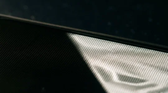Close-up view of illuminated AMOLED display showing perfect black pixels and vibrant content during late-night reading session